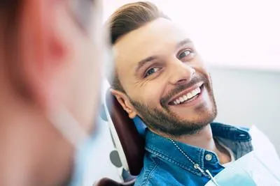 patient laughing with Dr. Meyer during his dental appointment