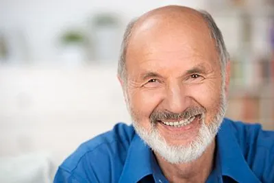 man smiling after getting dental implants at Meyer Dentistry