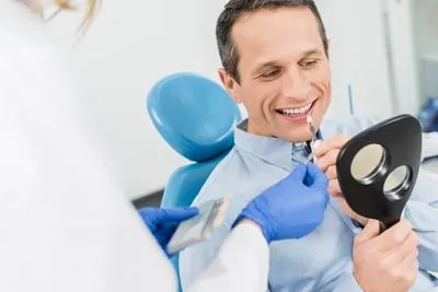 patient choosing a color for his dental veneers