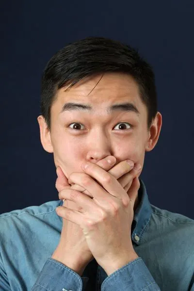 patient holding his mouth from tooth pain