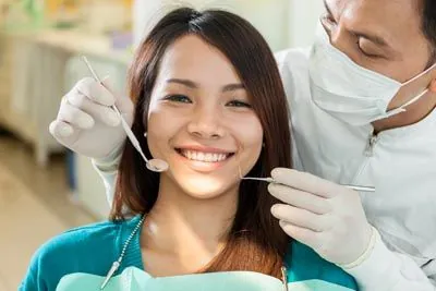 patient getting a dental checkup after an oral surgery procedure