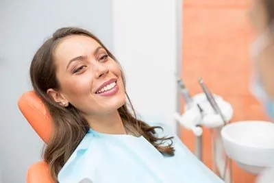 patient smiling after her oral surgery procedure